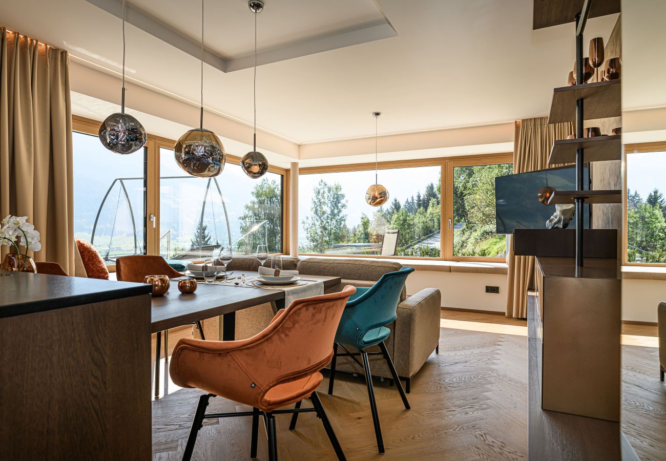 Dining area with large windows and mountain panorama in Bad Hofgastein
