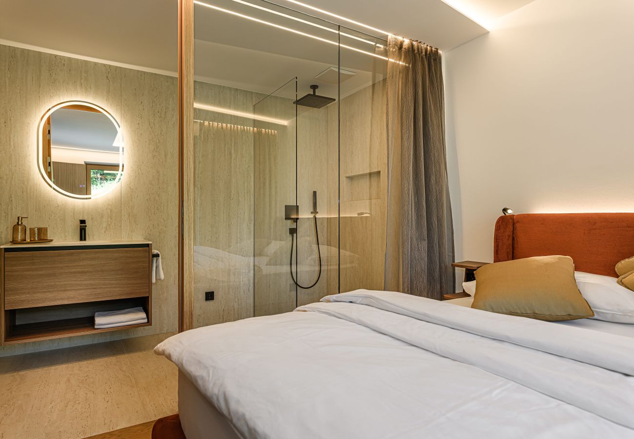 Bedroom with a double bed and modern bathroom in Design Apartments VIU by we rent