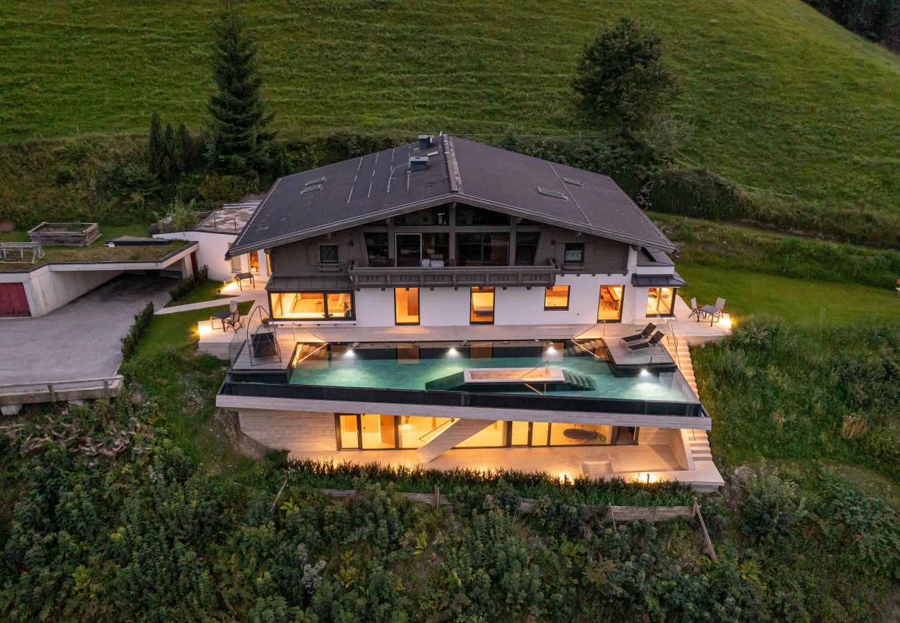 Aerial view of home in green mountains, with garden and quiet location, holiday flats by infinity pool and wellness.